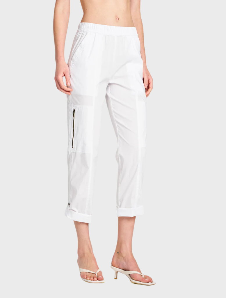 White Zip Cargo pants displayed on a hanger, showcasing a sleek design and functional pockets.