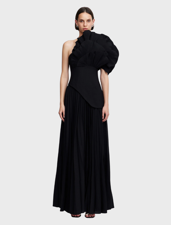 Elegant black Whittington gown displayed on a mannequin, showcasing its flowing fabric and sophisticated design.
