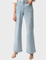 Light blue wide leg jeans on a neutral surface, emphasizing their casual style and comfortable design.