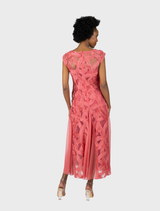 A chic Willow V-neck cocktail dress in blossom, designed with godet panels for a graceful and flowing appearance.