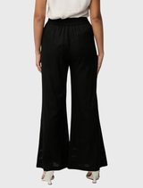 Black wide-leg trousers crafted from a linen-viscose blend, adorned with embroidery on the front leg and an elasticized waistband at the back.
