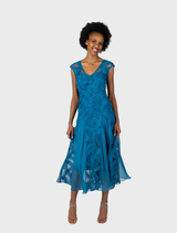 Teal Willow V-neck cocktail dress featuring a godet skirt for a flowing silhouette. Elegant and stylish for formal occasions.