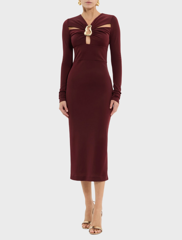  A stretchy burgundy dress with long sleeves and a decorative gold chain detail.