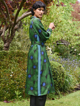 Winter-themed green floral dress, highlighting a tailored bodice and a soft, flowing skirt ideal for festive events.