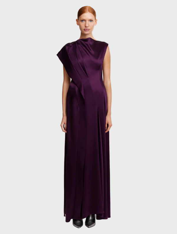  Sleeveless silk dress from The Row, showcasing a sleek design and elegant fabric in a soft, neutral color.