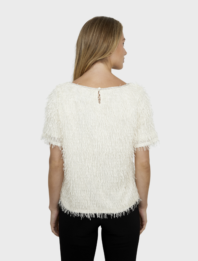 Soft vanilla knit top laid flat, showcasing its simple design and comfortable fabric ideal for casual occasions.