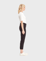 Black 7/8 pants with eyelet accents, highlighting a modern and chic look, displayed on a plain surface.