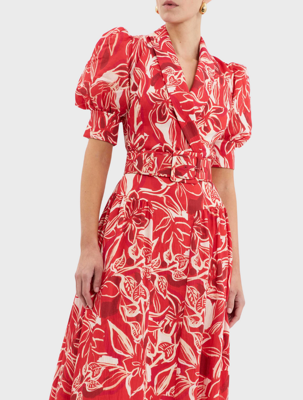 A red dress embellished with a striking white and red floral motif.