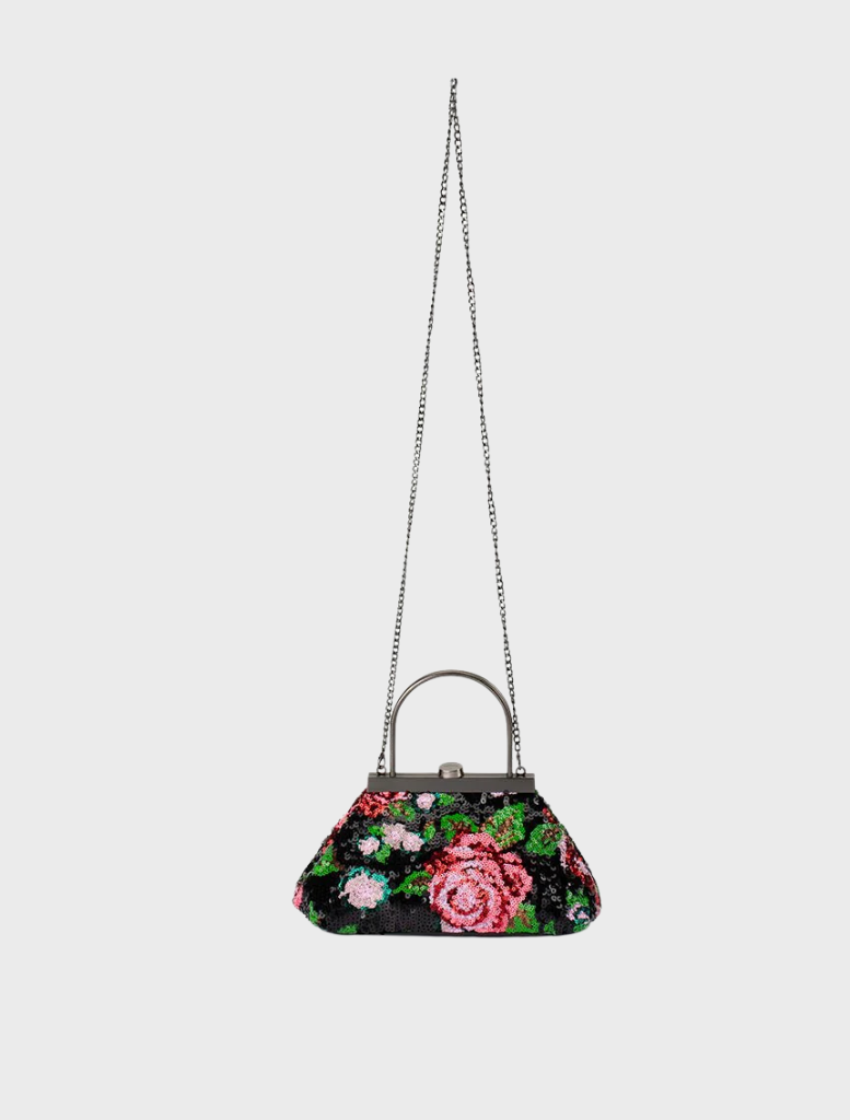 A black and pink floral purse with a metal handle, offering a blend of style and practicality for various occasions.

