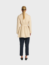 Stylish bisque wrap trench coat, designed with a belted waist and long sleeves, suitable for transitional weather.