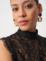Black lace top with a mock neck, cap sleeves, scalloped hem, and an invisible zipper, offering a refined appearance.
