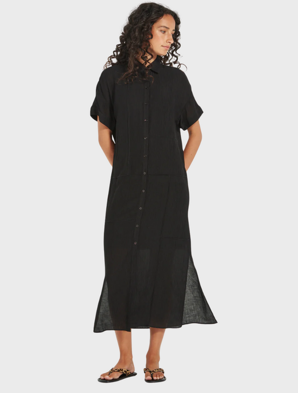A black shirt dress made of linen, highlighting its simple yet stylish silhouette.