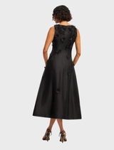 Stylish ebony midi dress by Cleo Petal, featuring a sleeveless design and a graceful, flowing skirt.