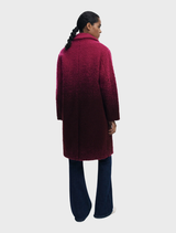 A fashionable ice cream pink coat on a hanger, featuring a smooth texture and contemporary design.