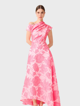Stylish pink floral maxi gown with an asymmetrical cut, elegantly arranged to showcase its design and colors.