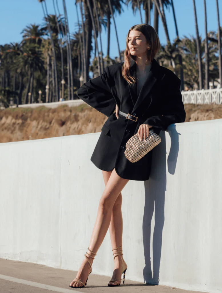 Chic gold woven clutch bag, made from a unique woven material, offering a touch of sophistication and style.