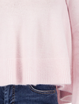 Flared light rose sweater, designed with long sleeves and a flowing silhouette for a chic, comfortable look.