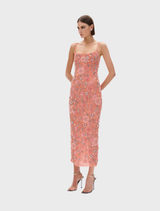 A peach gown from Francesca, embellished with floral motifs, elegantly draped on a mannequin against a neutral backdrop.