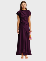 A long, flowing maxi dress in a rich fig color, featuring a relaxed fit and elegant design.