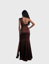 Sophisticated bronze gown with asymmetrical neckline, fitted bodice, flowing skirt, and daring leg split for elegant movement.