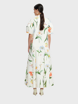 A chic ensemble consisting of a white floral print dress, a white blouse, and a white blazer, exuding sophistication.