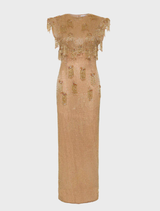 Elegant gold Lani gown displayed on a mannequin, showcasing its flowing fabric and intricate design details.