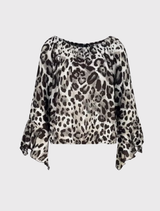 Stylish blouse featuring a leopard print, round neckline, and ⅞ trumpet sleeves, made from lightweight 100% viscose fabric.