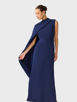 Elegant deep navy asymmetric cape dress by Leonara, showcasing a unique design perfect for special events.
3. Leonara's deep navy cape dress with an asymm