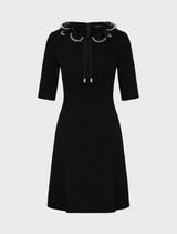 The image features a model in a chic black dress, accentuated by a bold slit for added flair.