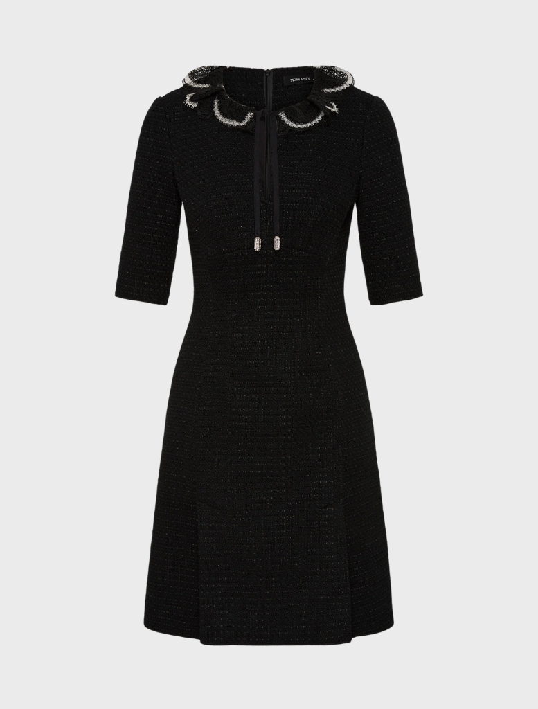 The image features a model in a chic black dress, accentuated by a bold slit for added flair.
