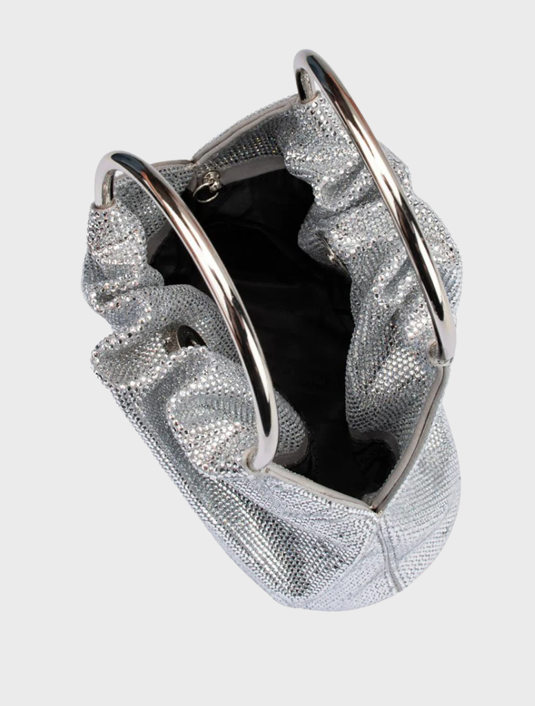 A fashionable silver purse with a distinctive metal handle, ideal for enhancing your ensemble with a touch of glamour.