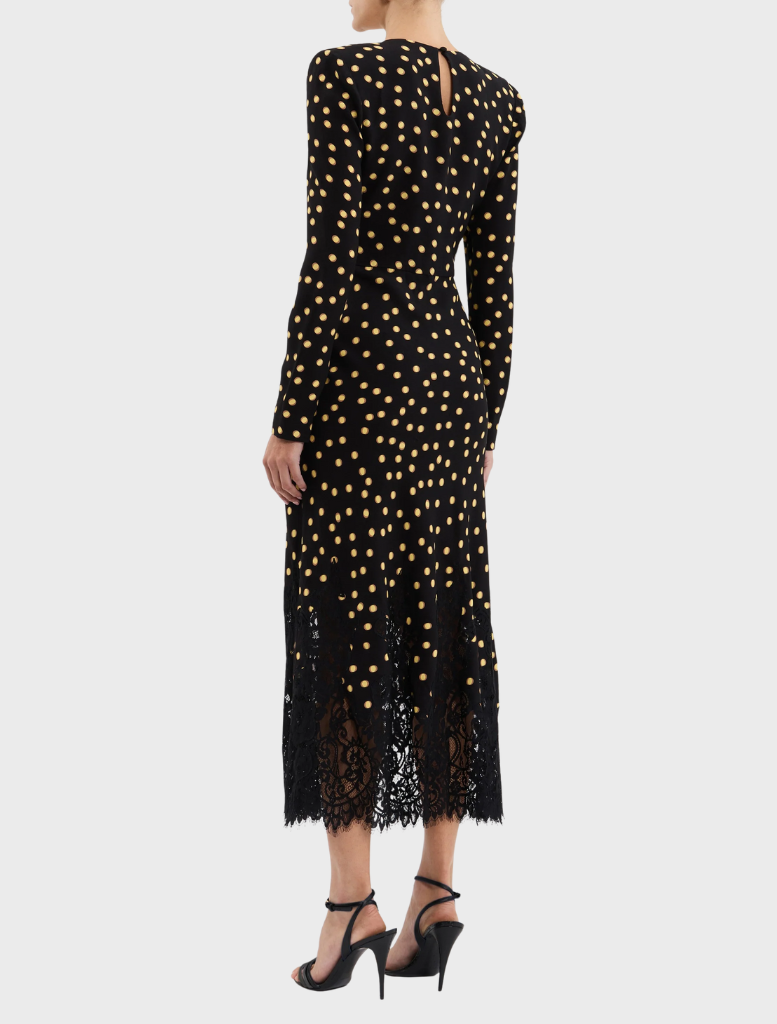A fashionable black dress with gold polka dots, accented by lace trim for added elegance.