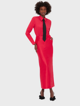 A woman wearing a red dress and a black tie, posing confidently with a stylish expression.