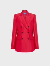 Back view of a woman in a tailored red suit, showcasing a professional and stylish appearance.