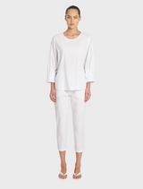 Elegant white cotton top with puff sleeves, perfect for adding a touch of style to any outfit.