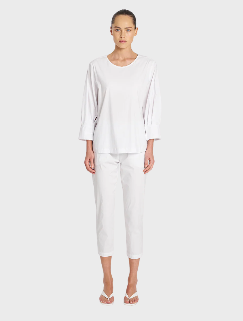Elegant white cotton top with puff sleeves, perfect for adding a touch of style to any outfit.