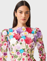 A multi floral long sleeve midi dress featuring a rosette design, showcased elegantly on a hanger.