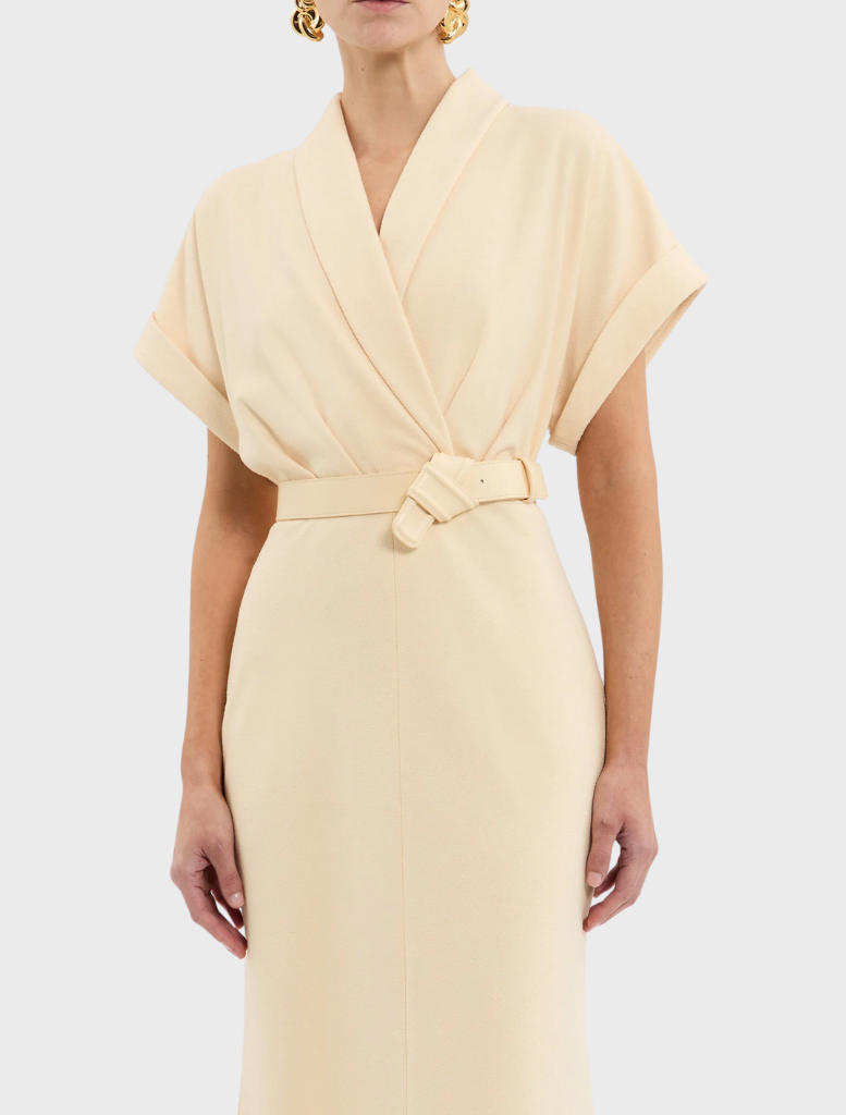 A cheerful yellow dress complete with a belt and collar, embodying a stylish and refined aesthetic.

