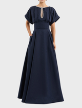 Elegant navy sapphire gown displayed on a mannequin, showcasing its flowing fabric and intricate design details.