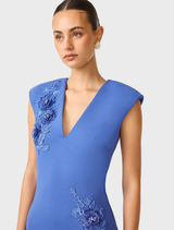 Elegant cornflower blue column dress by Talitha with a plunging neckline, showcasing a refined and stylish look.