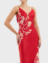 A red dress showcasing ornate gold and red flower patterns.