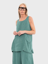 A green tank top displayed against a neutral background, showcasing its fabric texture and design