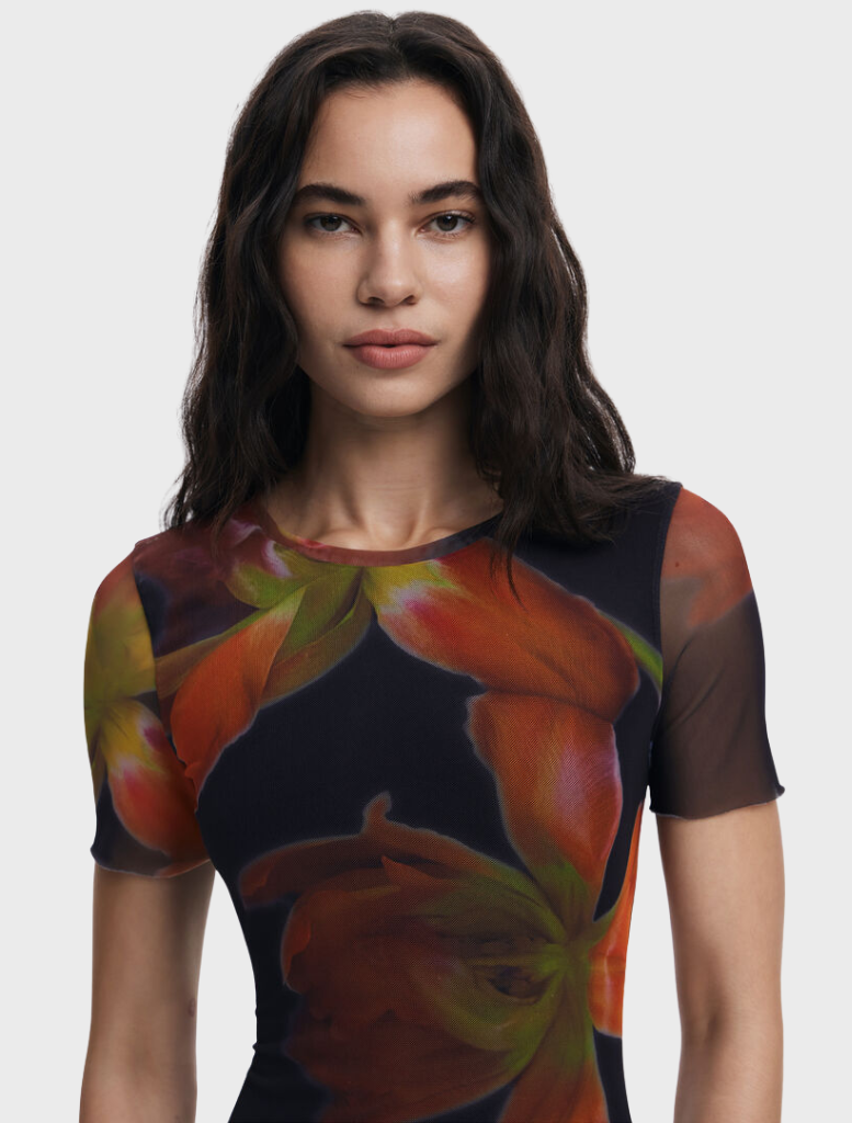 A black dress showcasing a beautiful floral design, offering a striking contrast between dark and colorful elements.