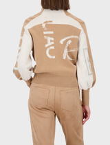 A stylish cognac patterned cardigan jacket draped on a hanger, emphasizing its elegant design and warm tones.