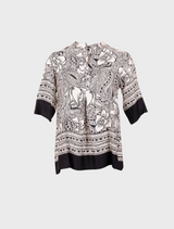 A chic top showcasing an elephant print, emphasizing detailed patterns in shades of gray on a contrasting background.