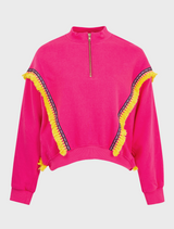 A woman with an afro wears a pink sweatsuit, embodying a chic and laid-back look.