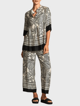 A chic top showcasing an elephant print, emphasizing detailed patterns in shades of gray on a contrasting background.