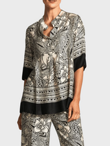 A top featuring a distinctive elephant print design, showcasing intricate patterns in shades of gray and black.