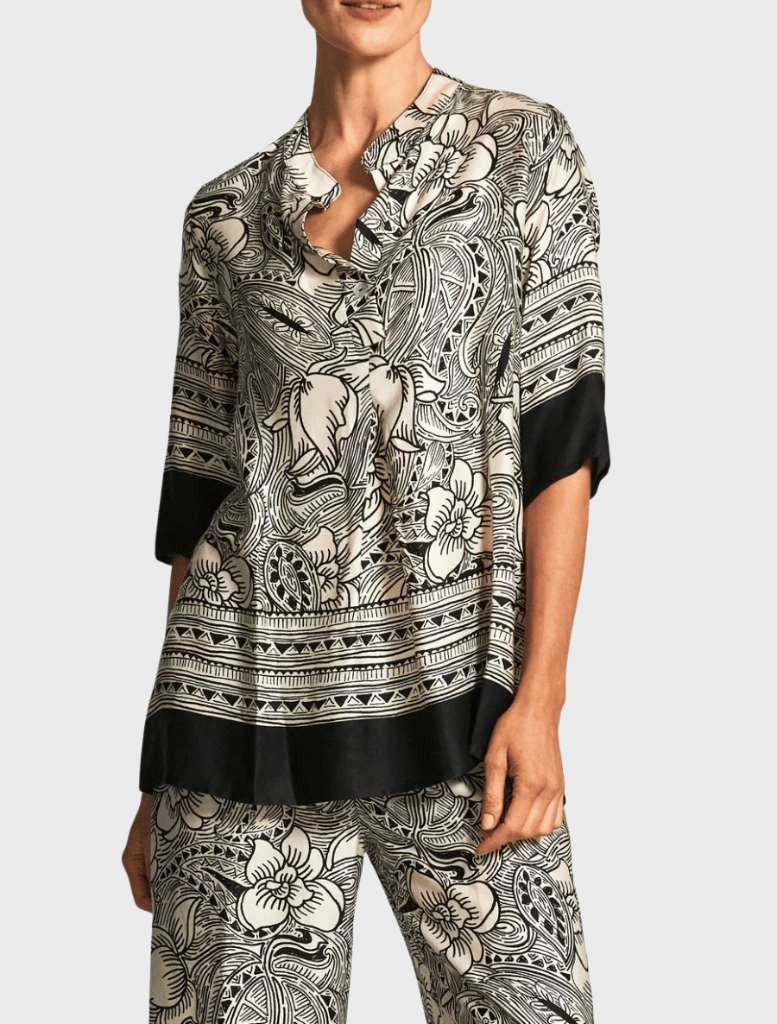 A top featuring a distinctive elephant print design, showcasing intricate patterns in shades of gray and black.