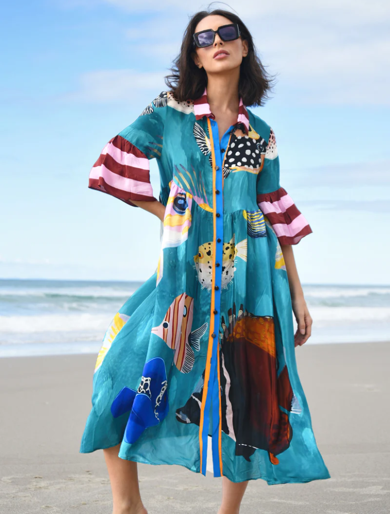 Colorful dress featuring a multi-fish print, perfect for a casual summer outing or beach day.